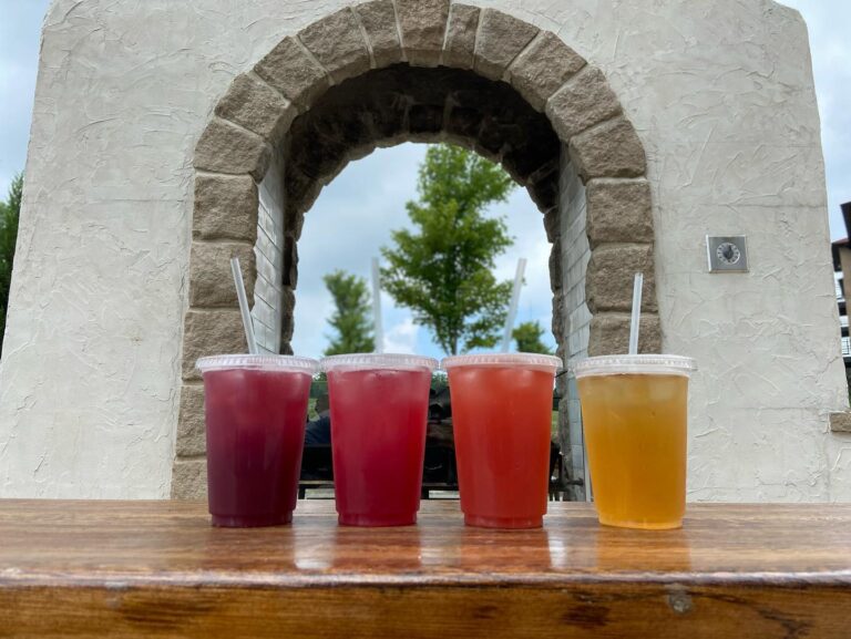 Four iced drinks with straws