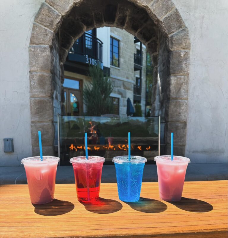 Four vibrant drinks on wooden table